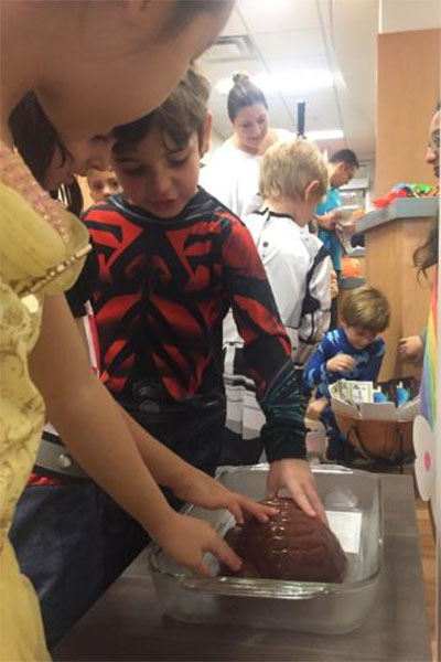 Kids in costumes exploring a jello brain